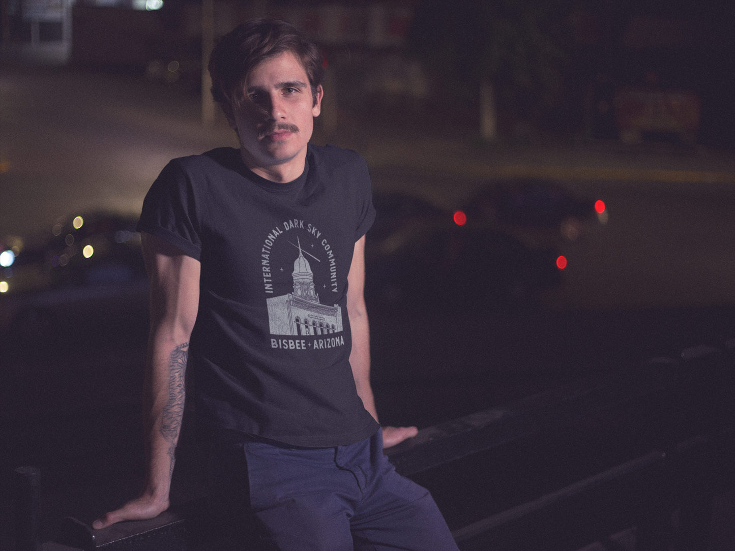 Man wearing a t-shirt that reads, "International Dark Sky Community Bisbee Arizona"