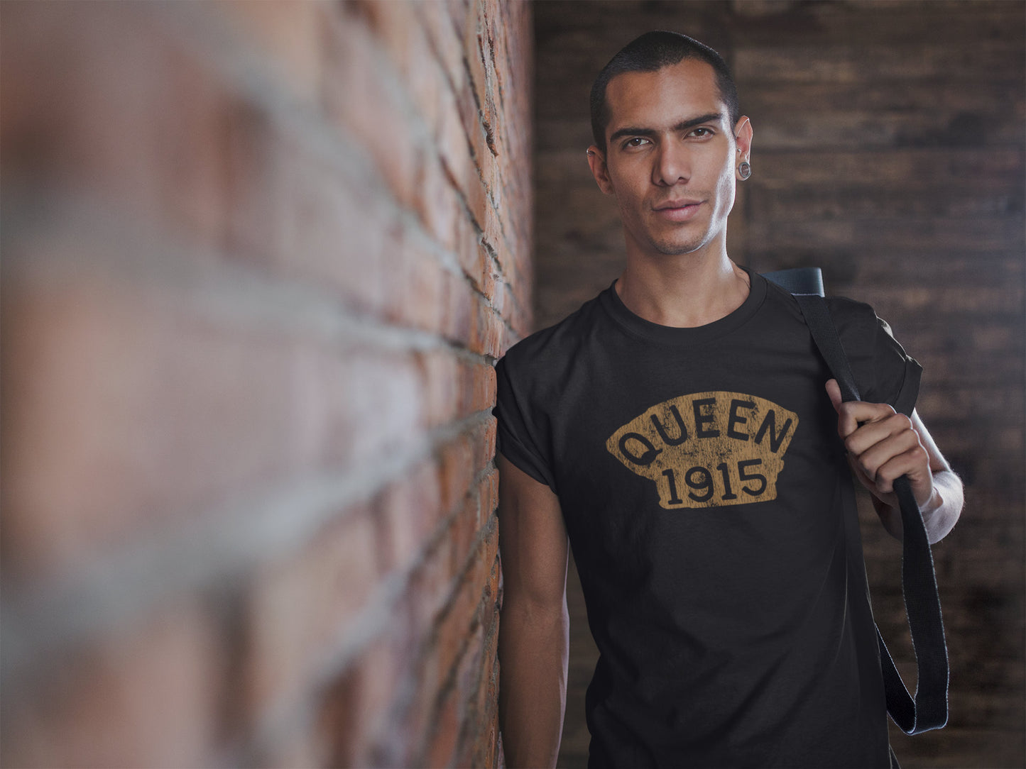 Man wearing a t-shirt with a design that reads, "Queen 1915"