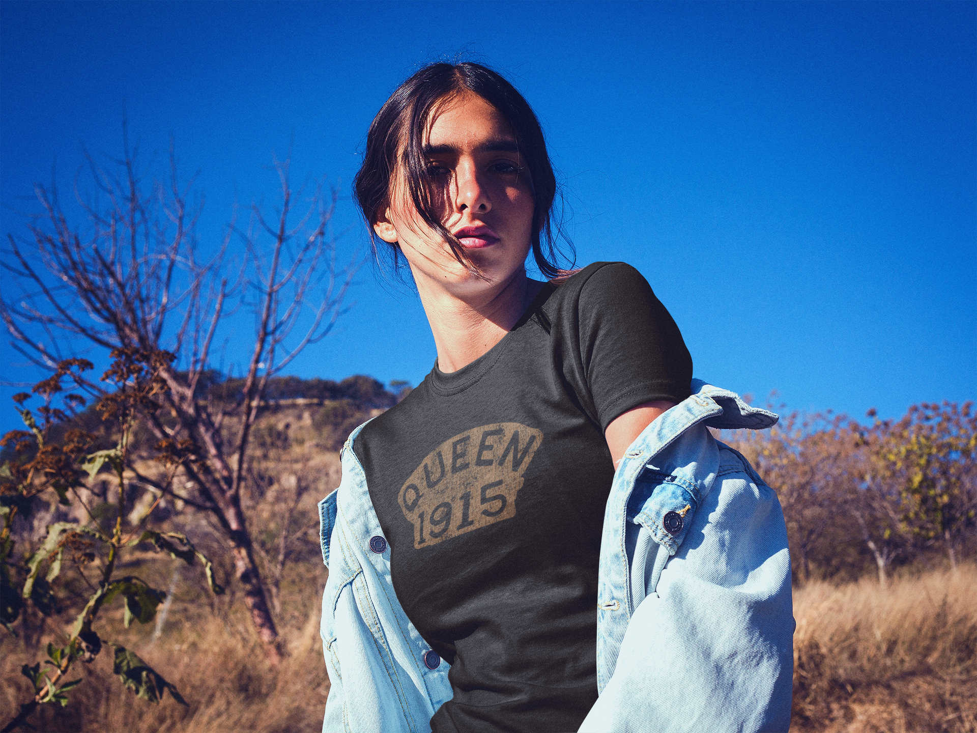Woman wearing a t-shirt featuring a plaque found at the Copper Queen Mine that reads, "Queen 1915"