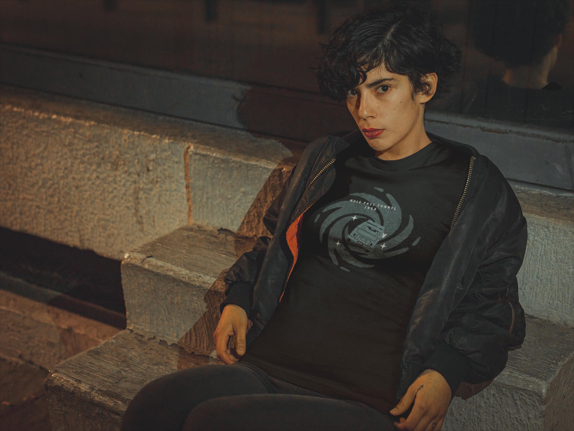 Woman wearing a t-shirt featuring the Mule Pass Tunnel in Bisbee, Arizona